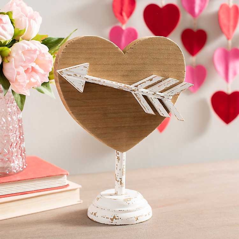 Wooden heart decor with whitewashed arrow through center on stand $15 each